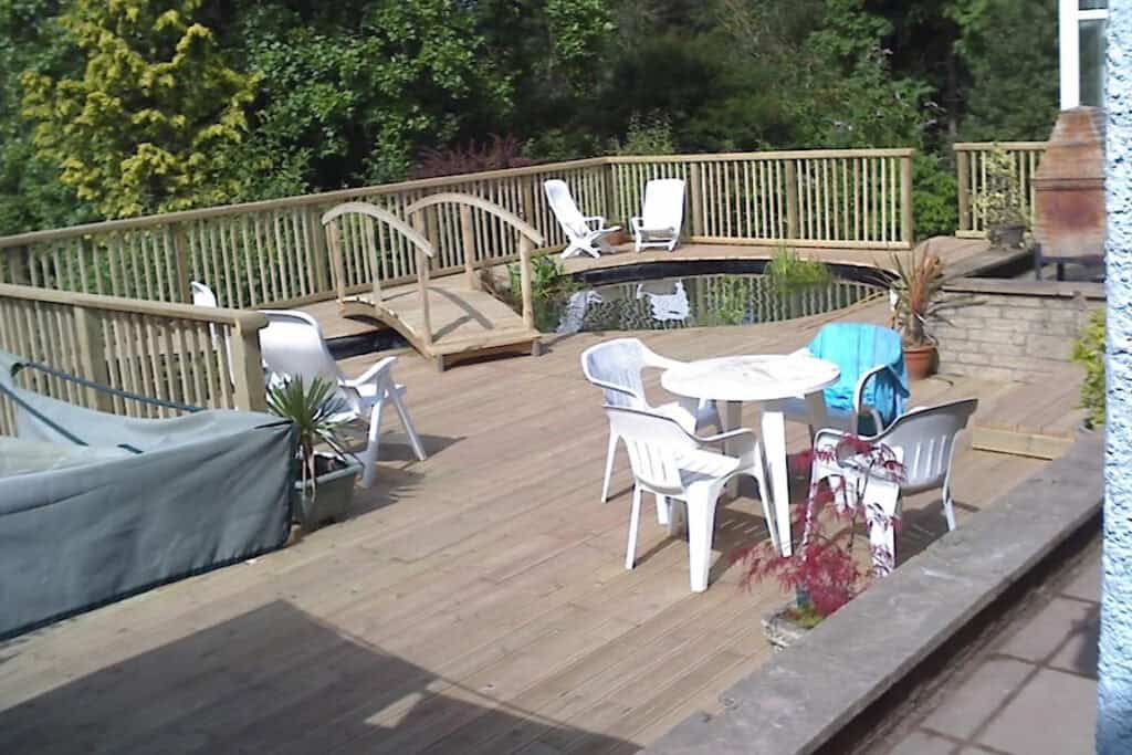 Change of lifestyle living with a new deck and integrated koi pond in Llantarnum, built by Turtle Productions
