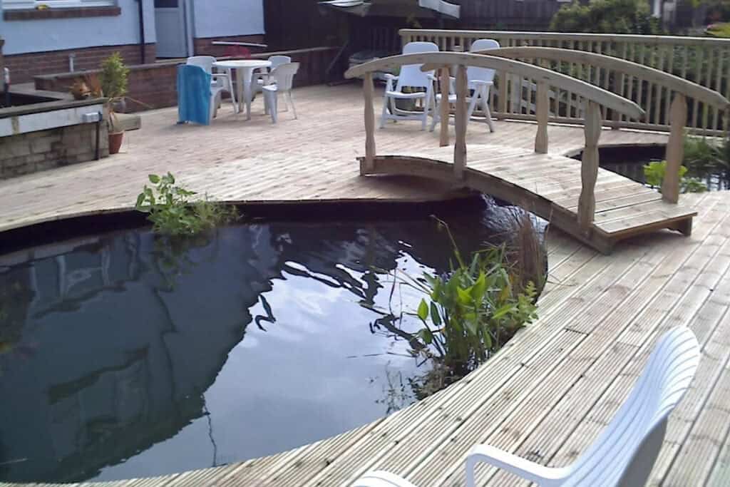 Change of lifestyle living with a new deck and integrated koi pond in Llantarnum, built by Turtle Productions