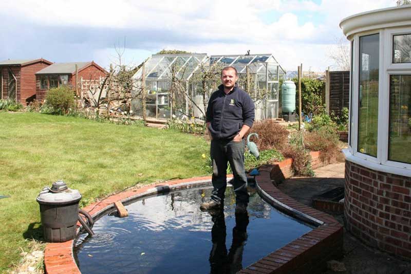 Child-safe garden pond with shallow planting and hidden safety grid