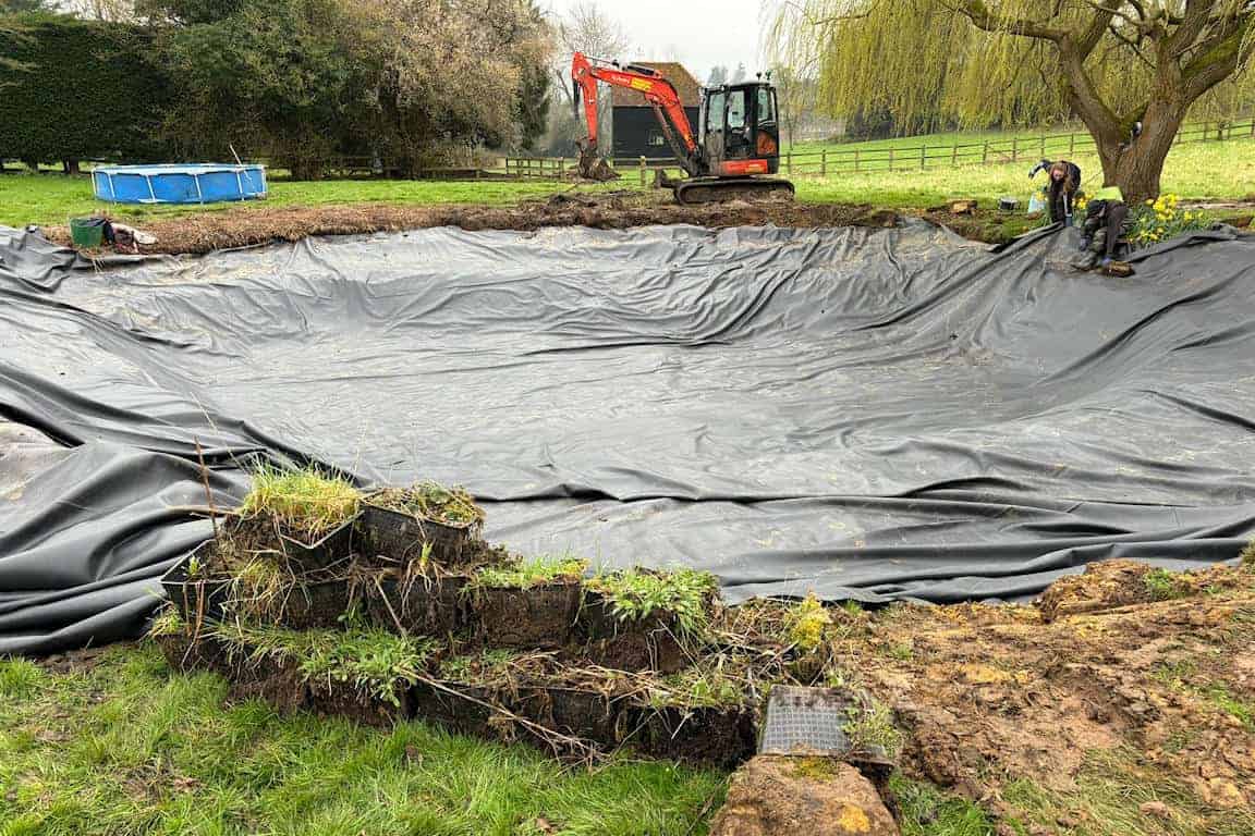EPDM pond liner being installed in a large lake project”